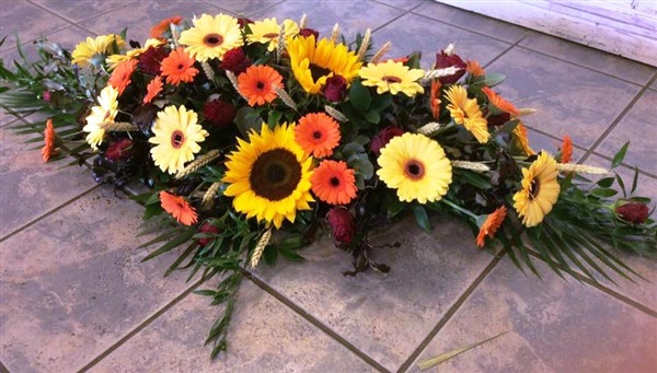 Casket spray, with Sunflowers, Gerbera and germini, yellows and orange/red