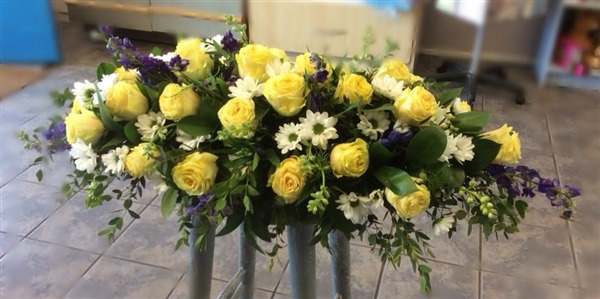 Casket Spray. Yellow buttercup roses and white daisy chrysanthemums