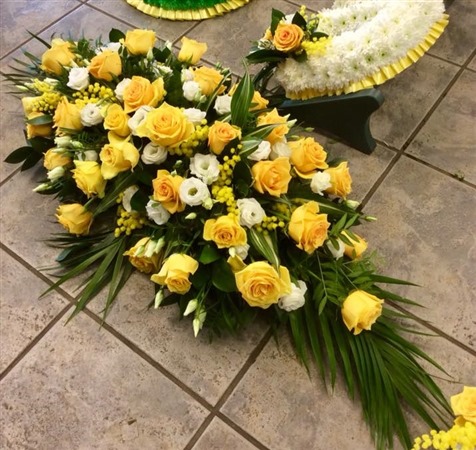 Casket Spray. Bright yellow roses, mimosa and white lisianthus 