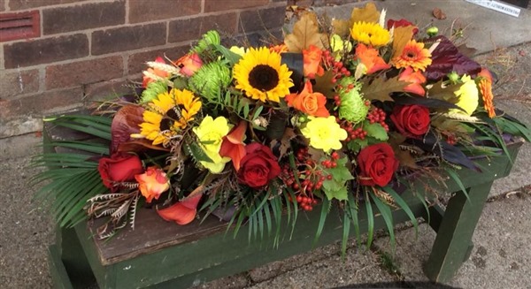 Casket Spray, Sunflowers, orange roses, red roses, Autumn leaves and berries