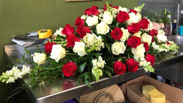 Casket Spray. Red and white roses with snaps