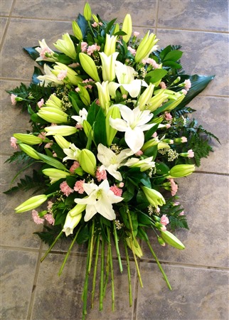 Casket Spray. White lilies with Pink Spray carnations