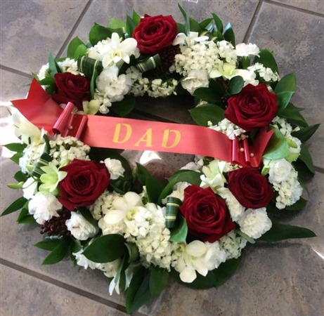 Wreath. Open style with white hydrangea and red roses. DAD ribbon
