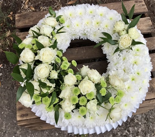 Wreath. Massed. White Spray roses and Green, white ribbon