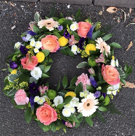 Wreath. Open style. Miss Piggy roses, germini, peach, colourful