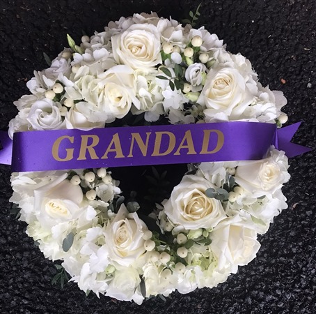 Wreath. Open style, white hydrangea and white roses. Grandad ribbon