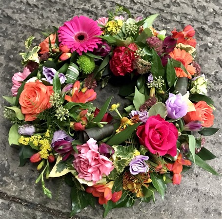 Wreath. Open style. Hot pink roses and orange, colourful 