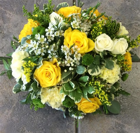Posy. Small domed posy with yellow and white roses, cream carnations.  