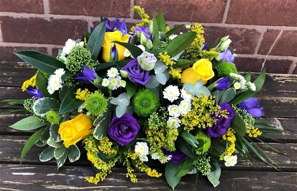 Posy. Long and Low, Yellow roses, purple lisianthus, yellow, purple and greens.