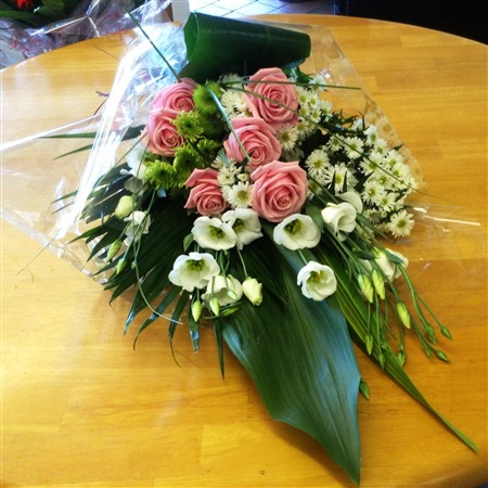 Sheaf. Funeral sheaf, pink roses and mixed white flowers 