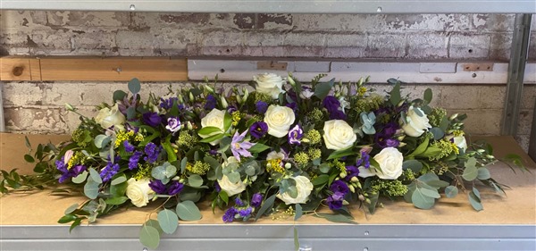 casket spray. white roses, clematis, and lisanthus