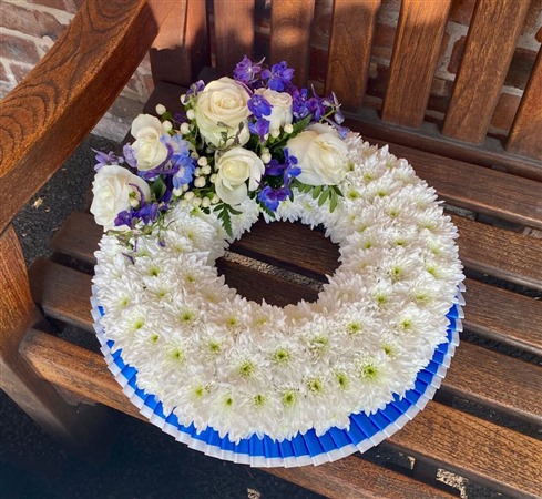 Wreath. Blue and white, massed, with blue spray