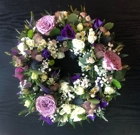 Wreath. Open style with lilac garden roses.